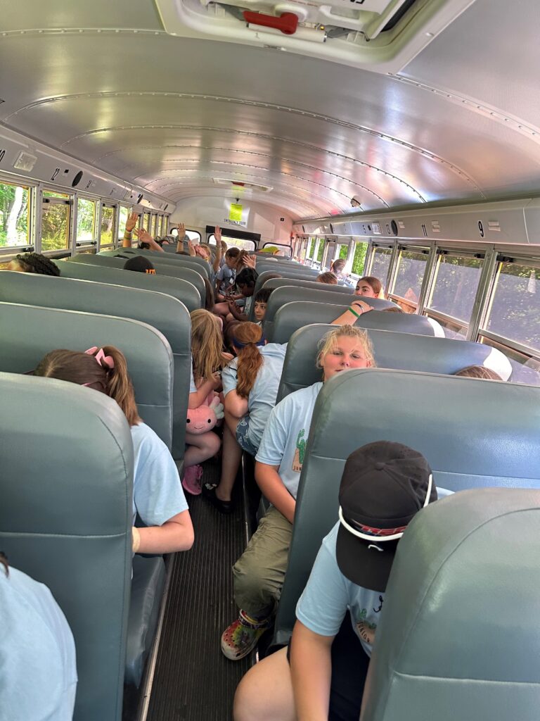 Kids riding on a bus.